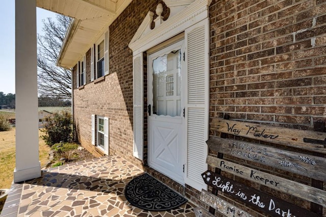 property entrance featuring brick siding