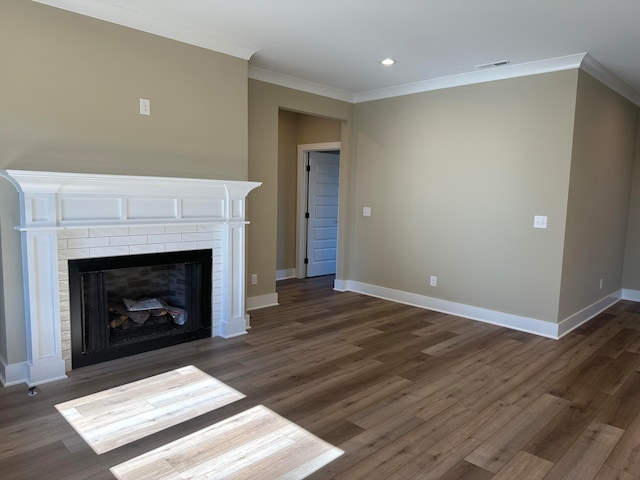 unfurnished living room featuring dark hardwood / wood-style floors, crown molding, and a fireplace