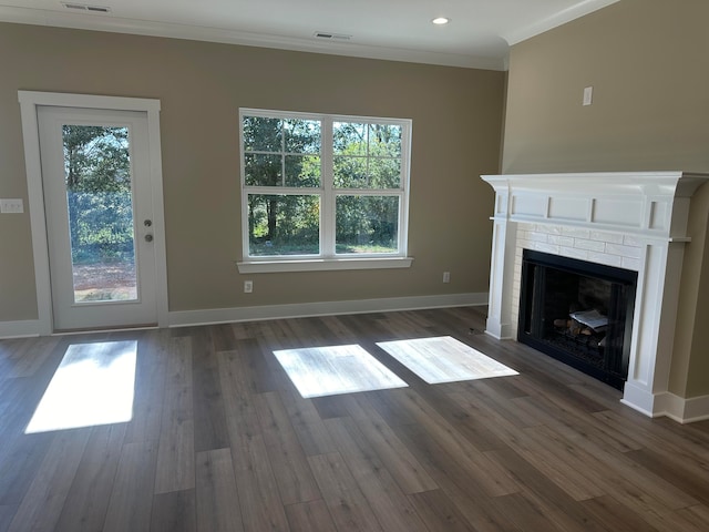 unfurnished living room with dark hardwood / wood-style floors, ornamental molding, and a fireplace