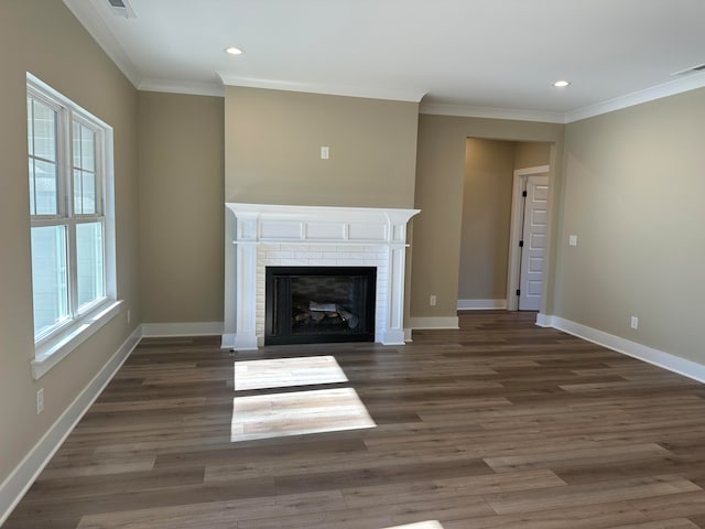 unfurnished living room featuring crown molding, a fireplace, and dark wood-type flooring