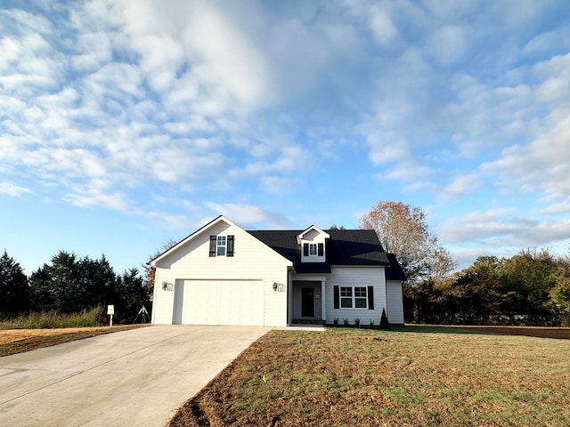 view of front of home with a front lawn and a garage