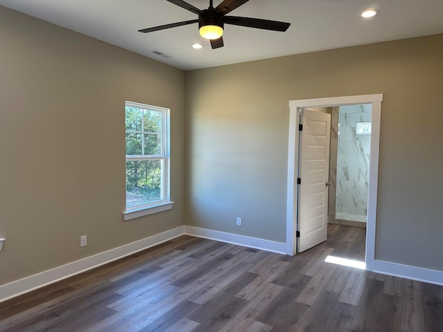 unfurnished bedroom with ceiling fan and dark hardwood / wood-style flooring