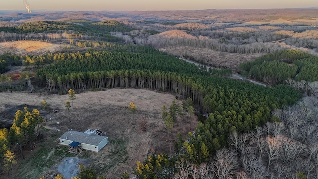 aerial view at dusk with a view of trees