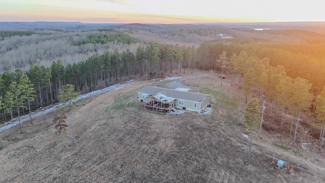 drone / aerial view with a wooded view