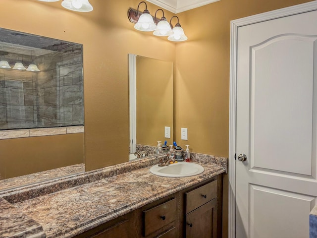 full bath with tiled shower and vanity