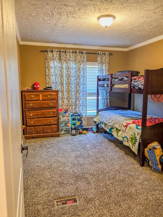 carpeted bedroom with ornamental molding, visible vents, and a textured ceiling