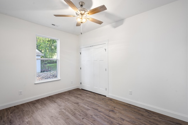 empty room featuring ceiling fan and dark hardwood / wood-style flooring