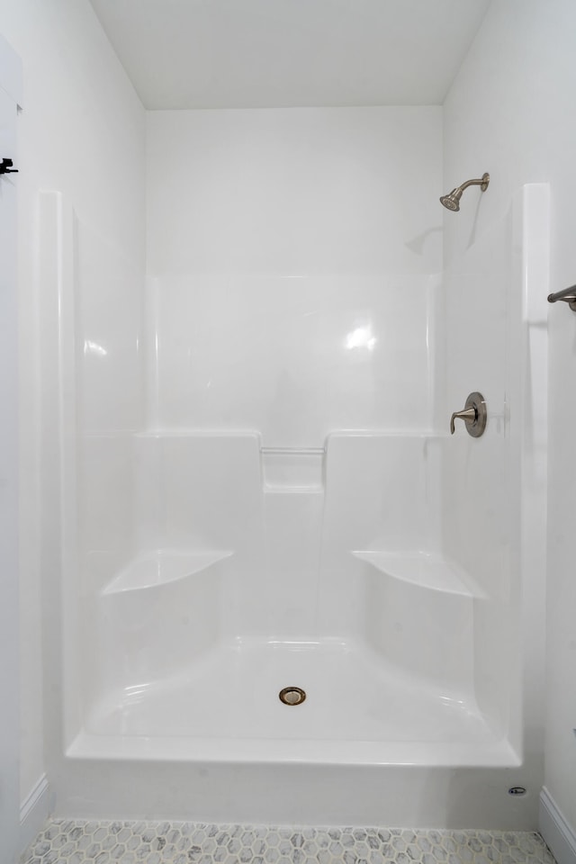 bathroom with tile patterned floors and a shower