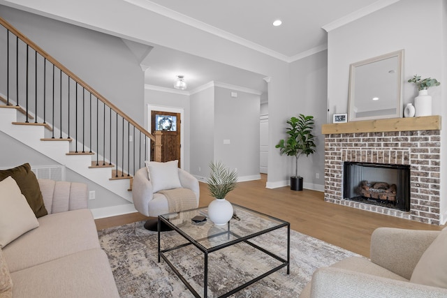 living area with stairs, ornamental molding, light wood-type flooring, and baseboards