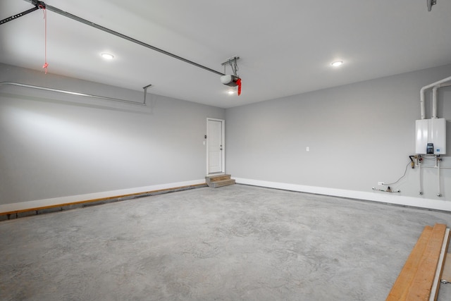 garage featuring a garage door opener, water heater, and baseboards