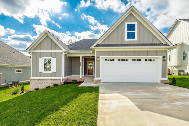 craftsman-style house featuring a garage, a shingled roof, driveway, board and batten siding, and a front yard