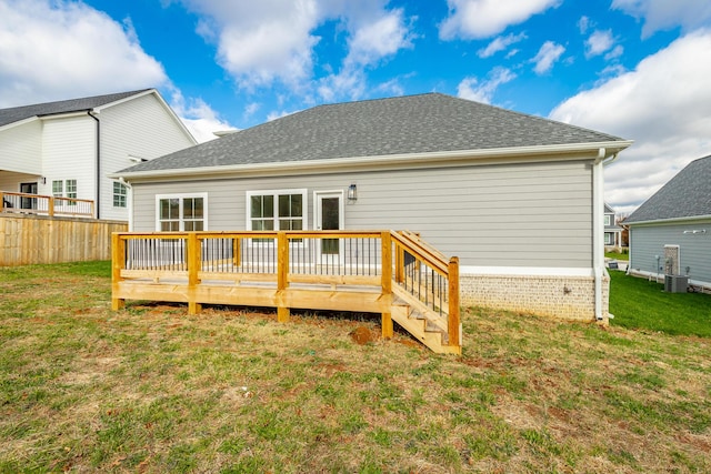 rear view of property with cooling unit, a yard, a deck, and fence