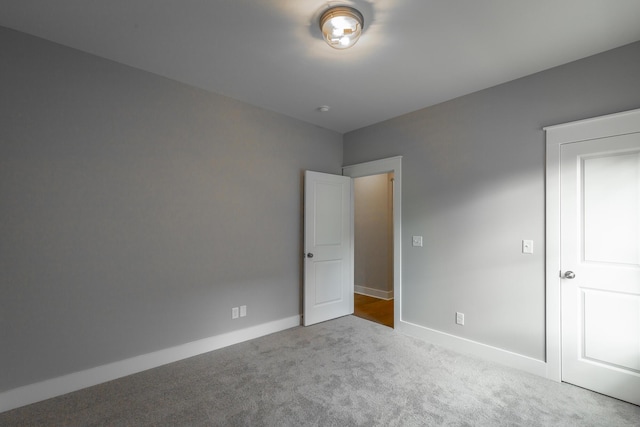 unfurnished bedroom with carpet floors and baseboards