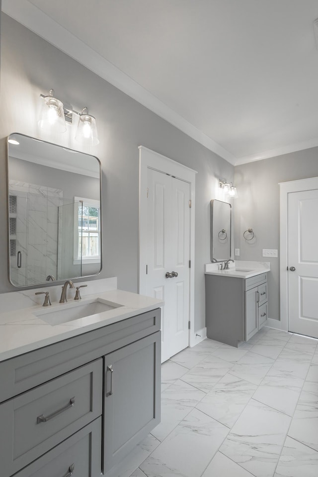 full bath featuring ornamental molding, marble finish floor, a sink, and a marble finish shower