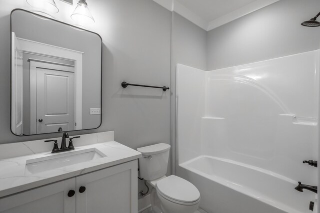 bathroom featuring washtub / shower combination, ornamental molding, vanity, and toilet