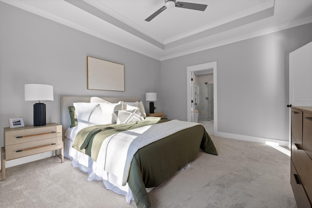 bedroom with ornamental molding, a raised ceiling, and light colored carpet