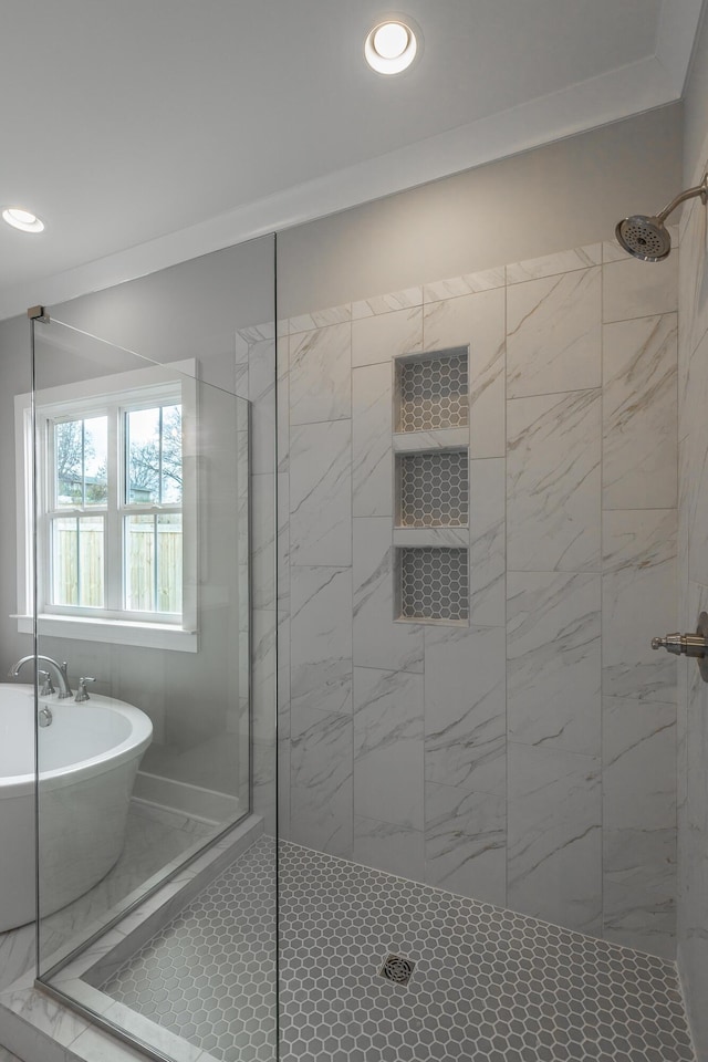 full bathroom with a soaking tub, a shower stall, and recessed lighting