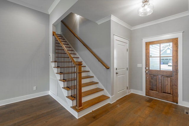 entrance foyer with crown molding, dark wood finished floors, stairway, and baseboards