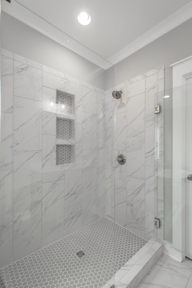 full bath with a stall shower and marble finish floor