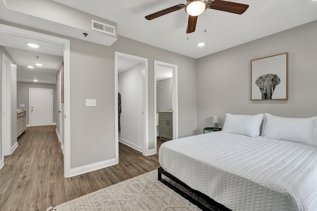 bedroom featuring wood-type flooring, connected bathroom, and ceiling fan