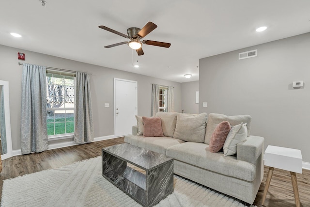 living room featuring ceiling fan and hardwood / wood-style floors