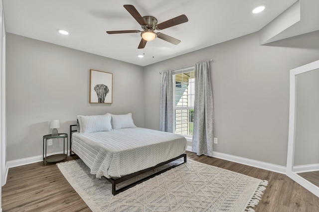 bedroom with ceiling fan and hardwood / wood-style flooring