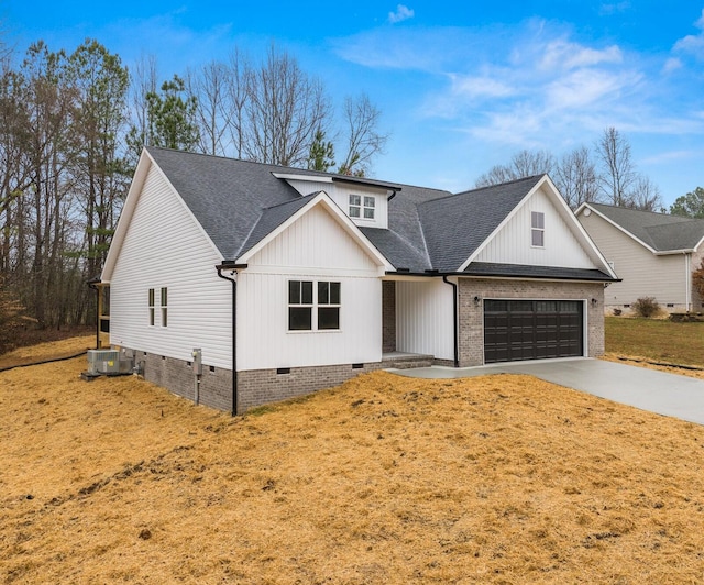 modern farmhouse with cooling unit, a garage, and a front yard