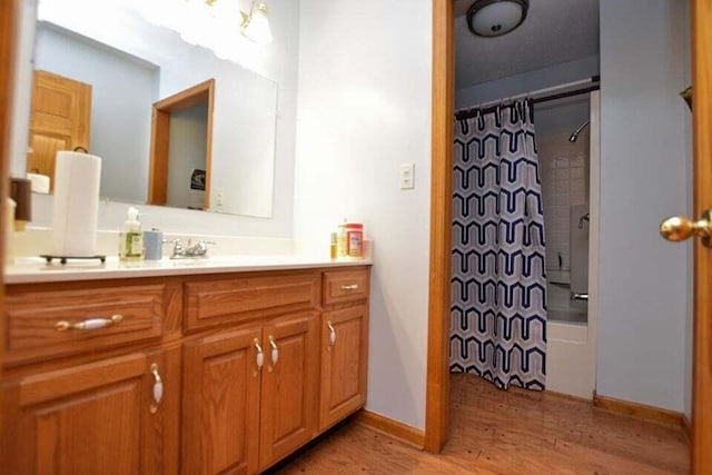 bathroom with shower / tub combo with curtain, vanity, and wood-type flooring