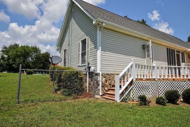 rear view of property with a lawn and a deck