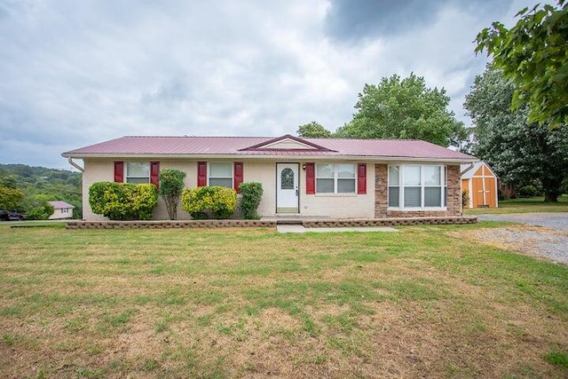 ranch-style house with a front lawn and a storage shed