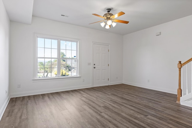 unfurnished living room featuring ceiling fan and dark hardwood / wood-style floors