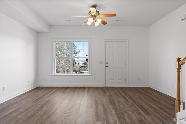 spare room with ceiling fan and dark hardwood / wood-style floors