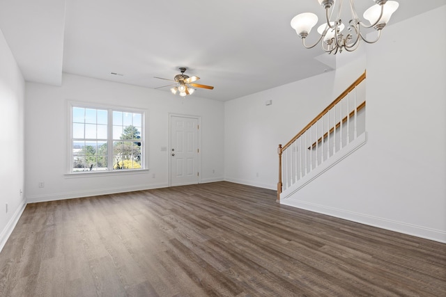 unfurnished living room with ceiling fan with notable chandelier and dark hardwood / wood-style floors