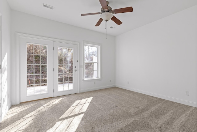 carpeted spare room with ceiling fan