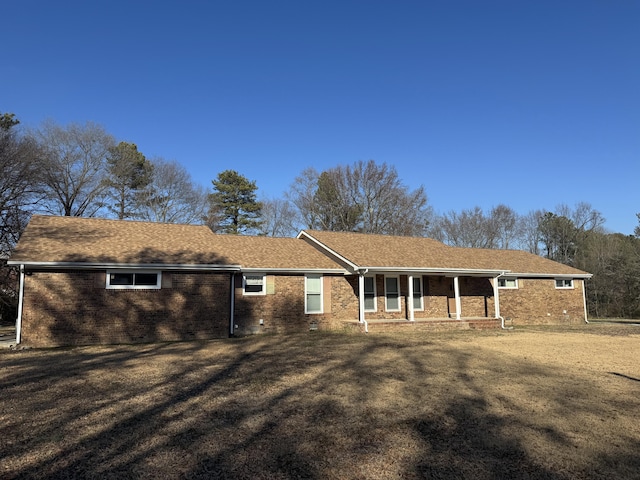 single story home with a front lawn and a porch