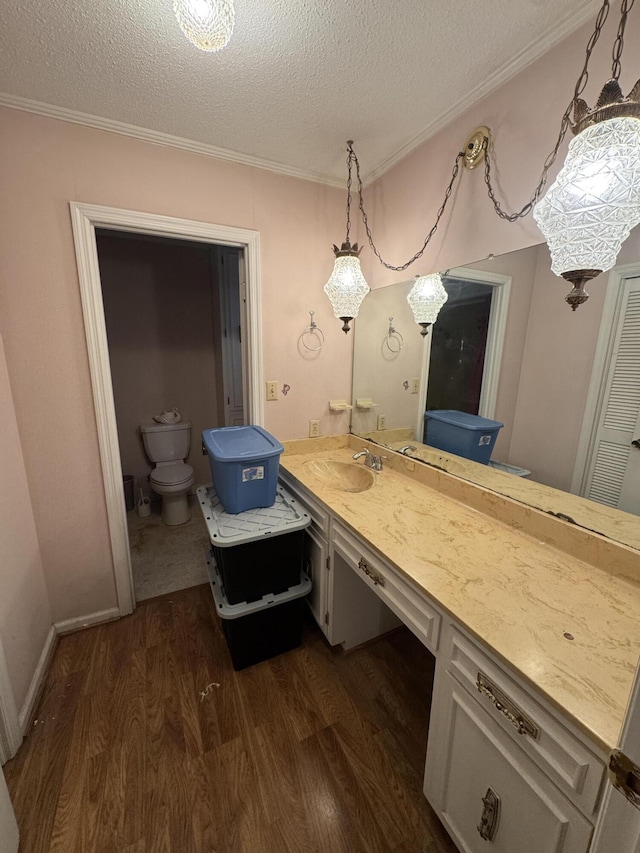 bathroom featuring vanity, crown molding, a textured ceiling, and hardwood / wood-style floors