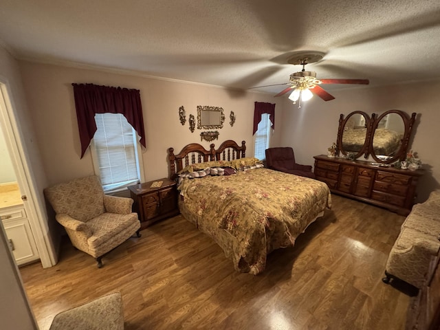 bedroom featuring a textured ceiling, ceiling fan, and hardwood / wood-style flooring