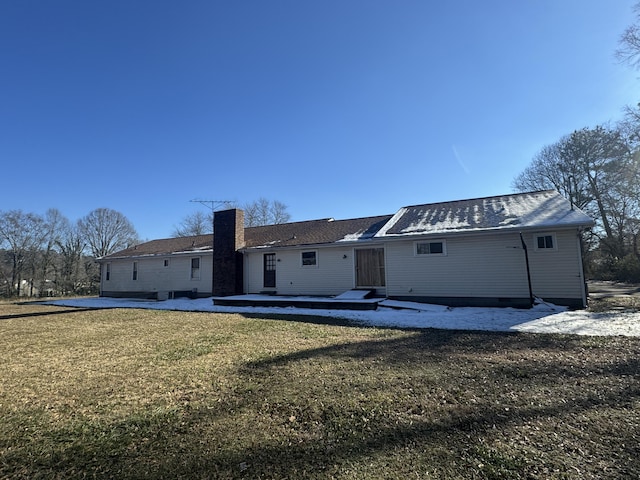 rear view of house with a lawn