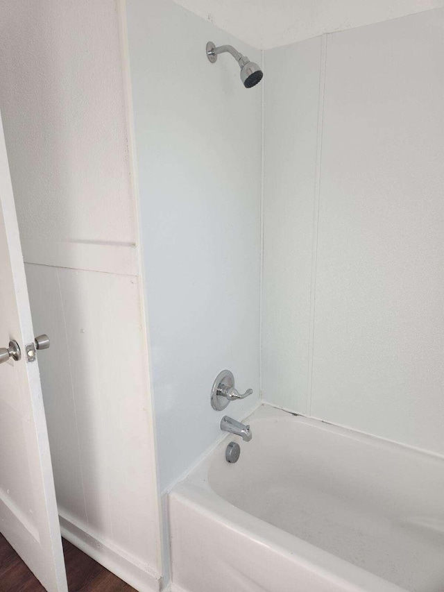 bathroom featuring hardwood / wood-style flooring and tub / shower combination