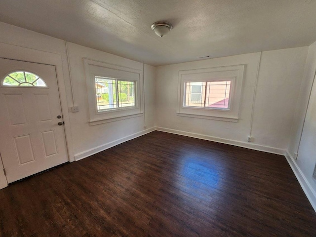 entryway featuring dark hardwood / wood-style floors and a textured ceiling