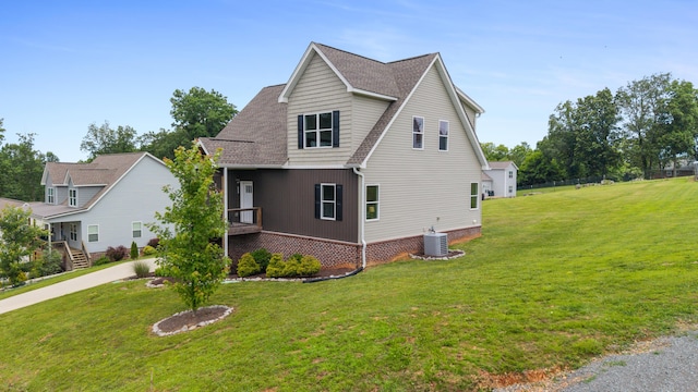 155 Surrey Ln NE, Cleveland, TN 37312 - view of property exterior featuring a lawn and a shingled roof