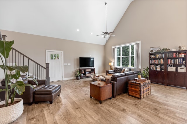 155 Surrey Ln NE, Cleveland, TN 37312 - living area with high vaulted ceiling, light wood finished floors, ceiling fan, and stairs