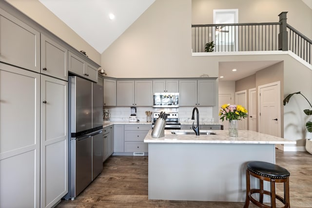 155 Surrey Ln NE, Cleveland, TN 37312 - kitchen featuring appliances with stainless steel finishes, gray cabinetry, high vaulted ceiling, dark wood-style floors, and backsplash