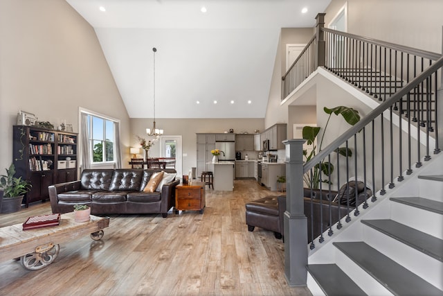 155 Surrey Ln NE, Cleveland, TN 37312 - living area with high vaulted ceiling, light wood-style flooring, stairs, and a chandelier