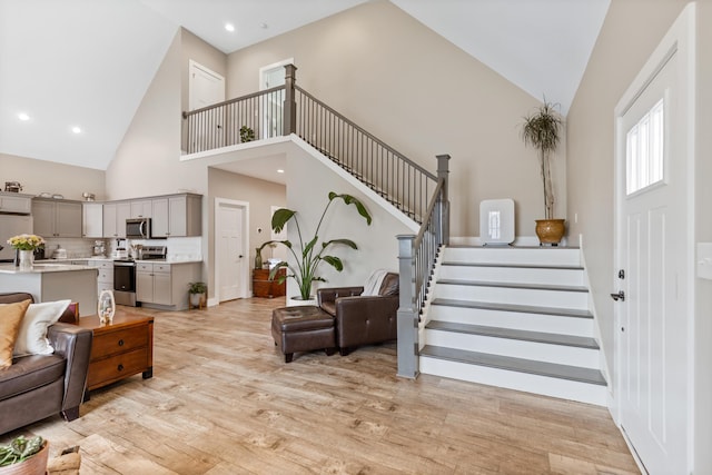 155 Surrey Ln NE, Cleveland, TN 37312 - living room with high vaulted ceiling, stairway, light wood-style floors, and recessed lighting