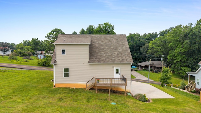 155 Surrey Ln NE, Cleveland, TN 37312 - rear view of house featuring roof with shingles, a yard, and a wooden deck
