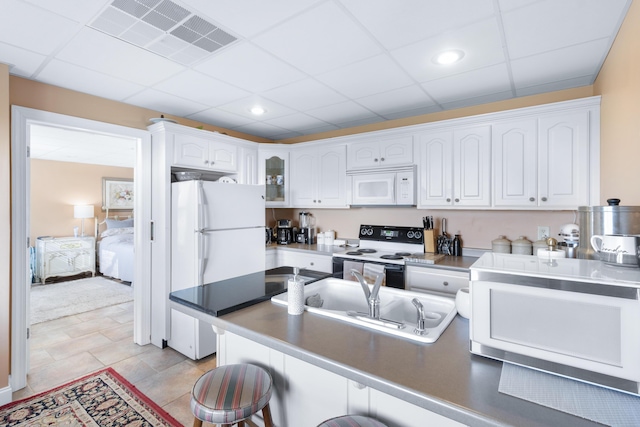 103 Windcrest Pl NW, Cleveland, TN 37312 - kitchen featuring white appliances, a sink, white cabinetry, a kitchen bar, and a paneled ceiling