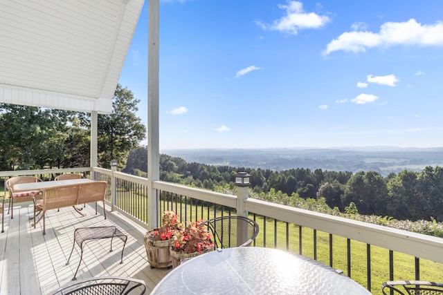 103 Windcrest Pl NW, Cleveland, TN 37312 - wooden terrace with outdoor dining area, a wooded view, and a lawn