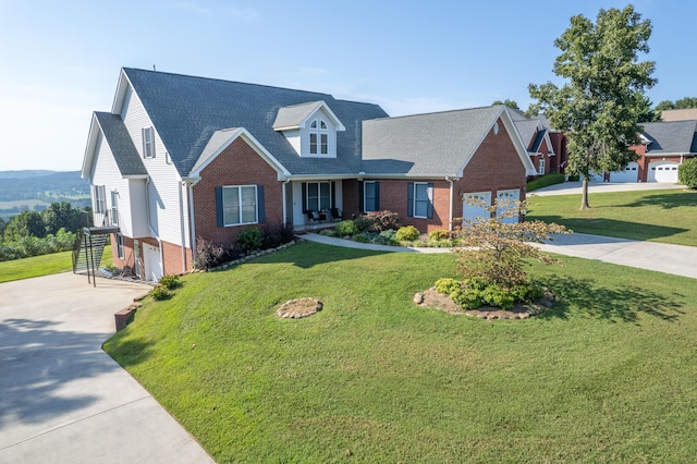 103 Windcrest Pl NW, Cleveland, TN 37312 - new england style home featuring concrete driveway, brick siding, a garage, and a front yard