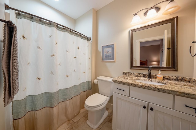 bathroom featuring curtained shower, vanity, toilet, and tile patterned floors